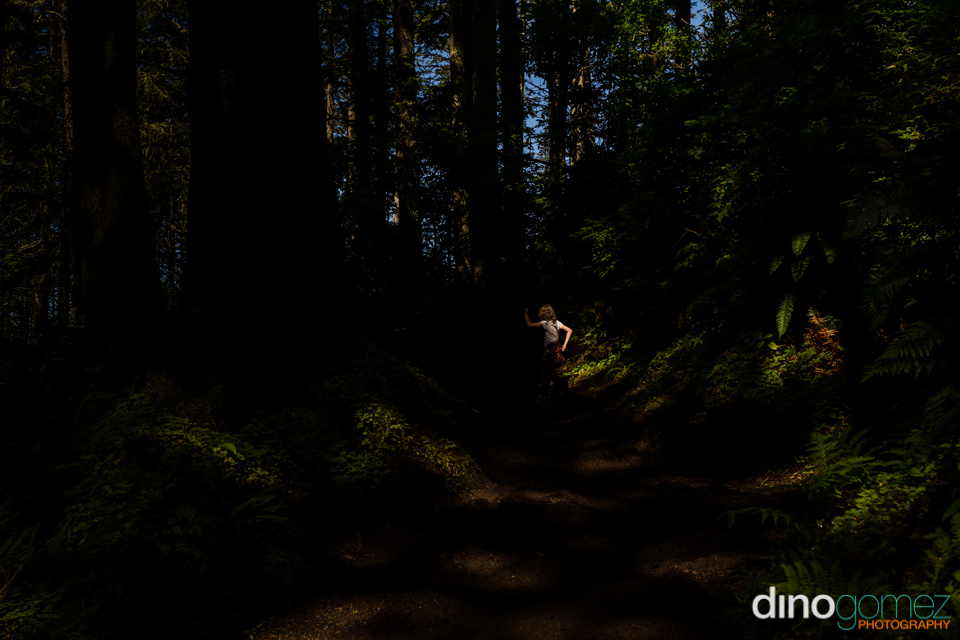 Young Girl Dancing In The Woods With The Sunlight Peaking In Through The Leaves In Portland, Or