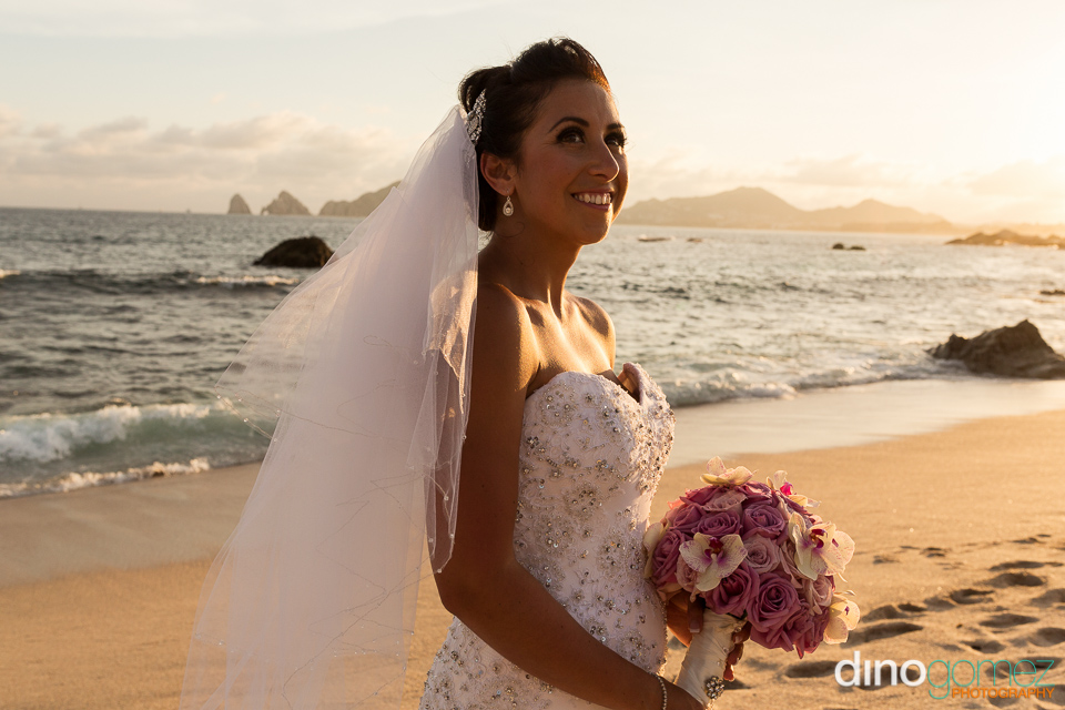 Beautiful Bride Poses With A Bouquet Of Flowers On The Beach After The Wedding Ceremony