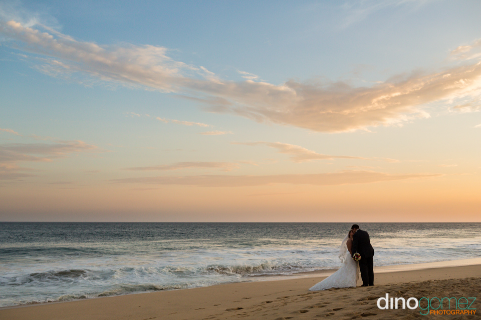 A Shot Of The Newlywed Couple Kissing On An Exotic Beach By The Talented Destination Wedding Photographer Dino Gomez