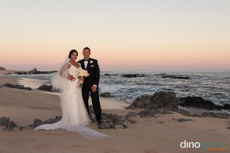 Destination Wedding Couple Posing On Beach Together