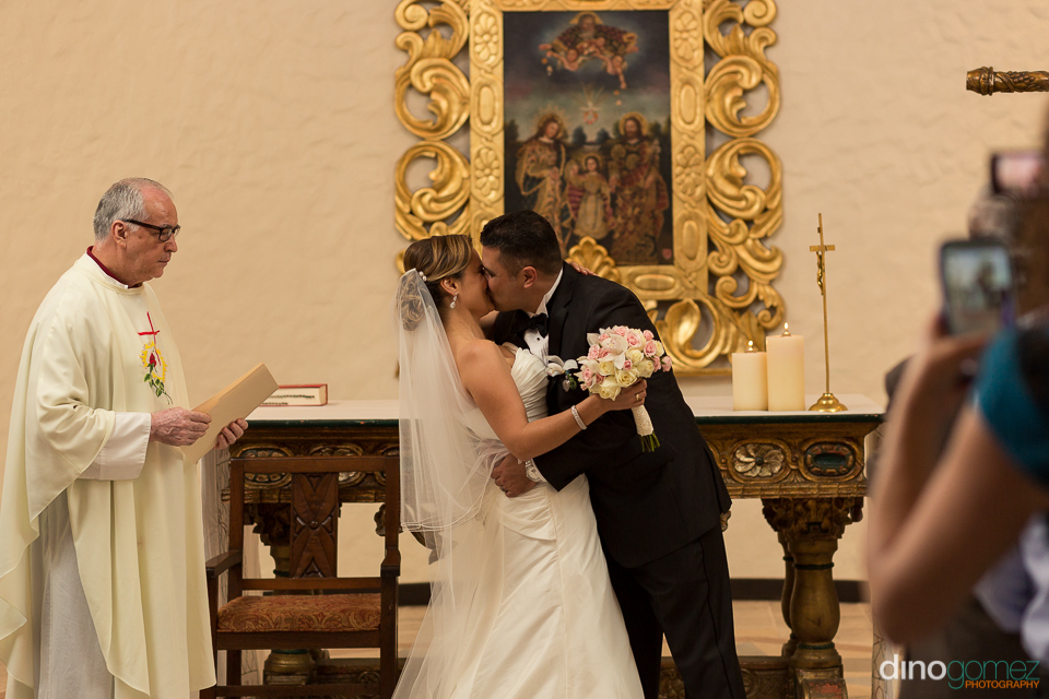 Bride And Groom Sharing Their First Kiss As Husband And Wife In Mexico