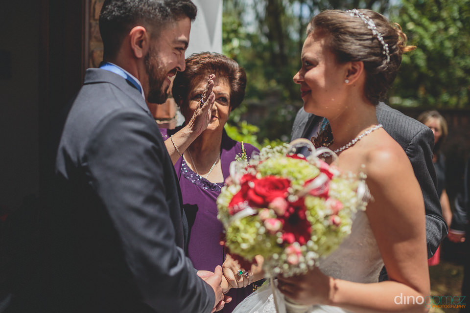 Blissful Bride and Groom Stand Together With Family