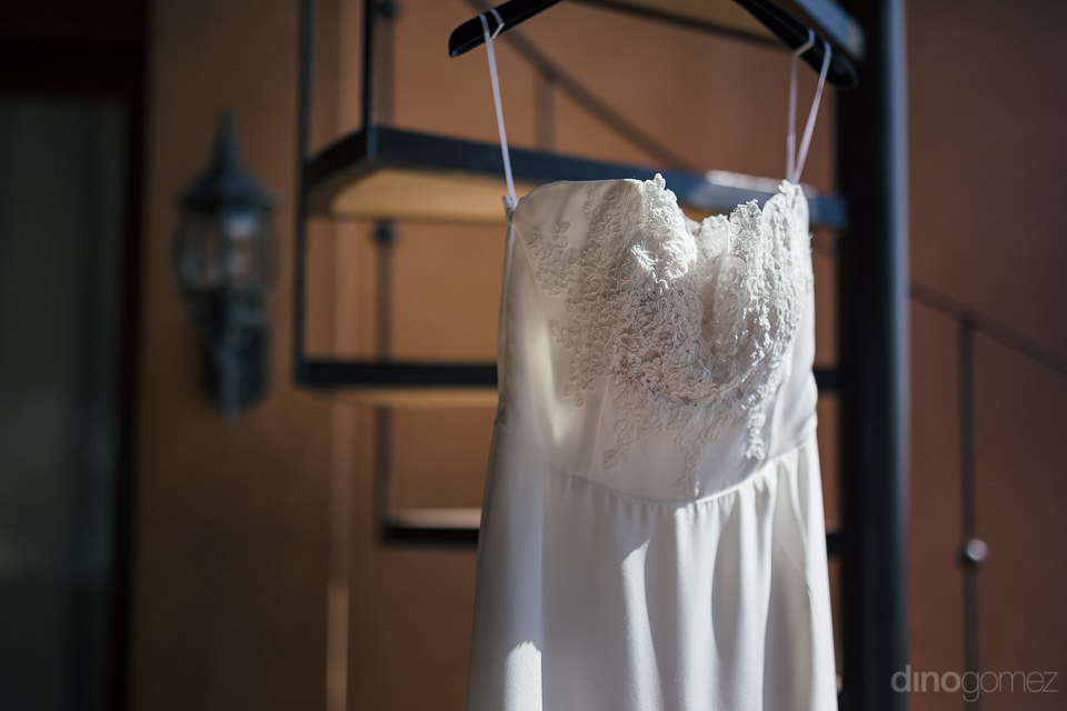 Luxurious White Sleeveless Wedding Dress Hanging Up Before Weddi