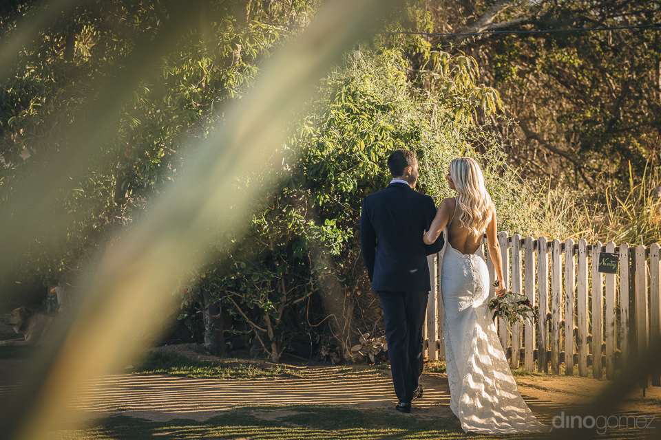 Newlyweds Walk Around Flora Farms In Charming Wedding Photo By D