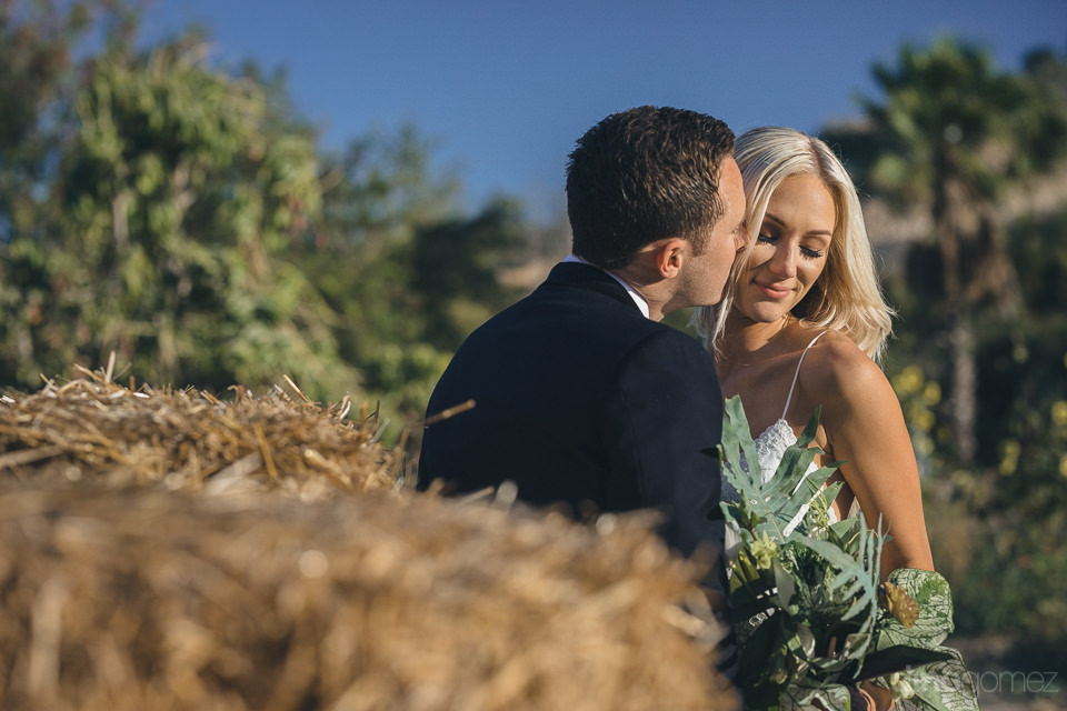 Kissing By The Hay Bales – Flora Farms Destination Wedding