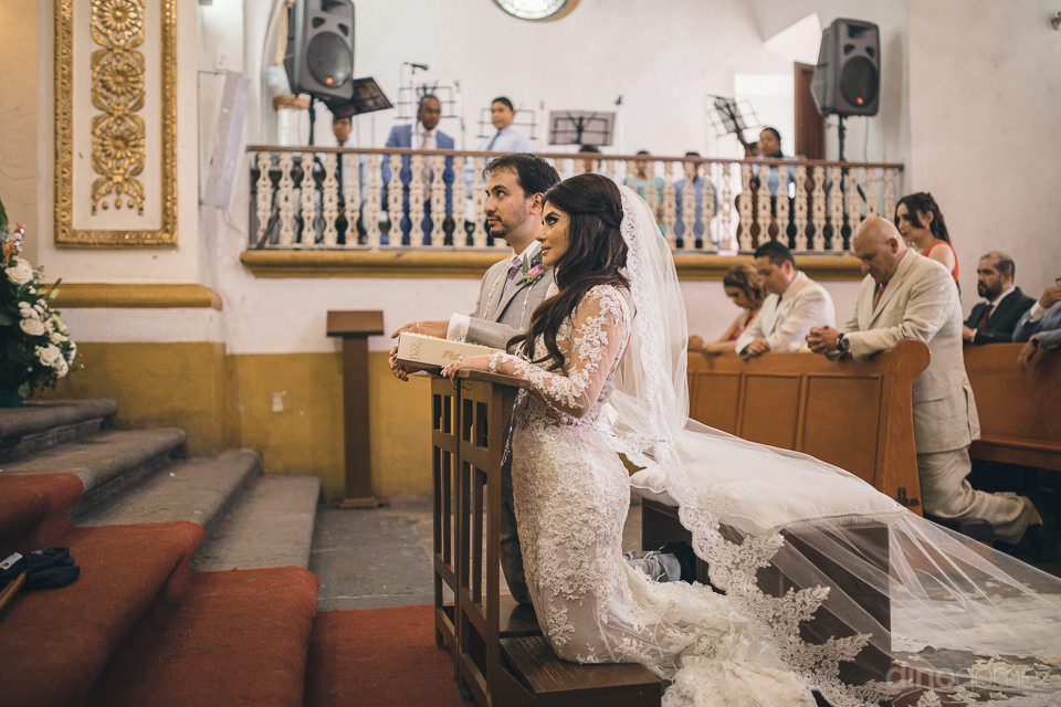Bride And Groom Kneel For Wedding Ceremony In Mexico Church