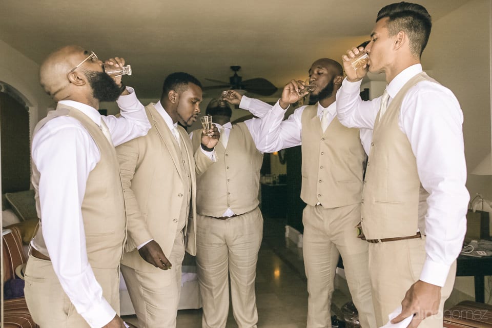 Groom and his friends are standing inside the palace and are taking shots of drinks before leaving for the wedding stage- Amber & Josh