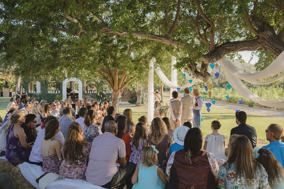 The Picture Beautifully Captures The Vow Exchanging Ceremony Of The Gorgeous Couple With All The Guests Sitting During The Ceremony- Lara & Darrell