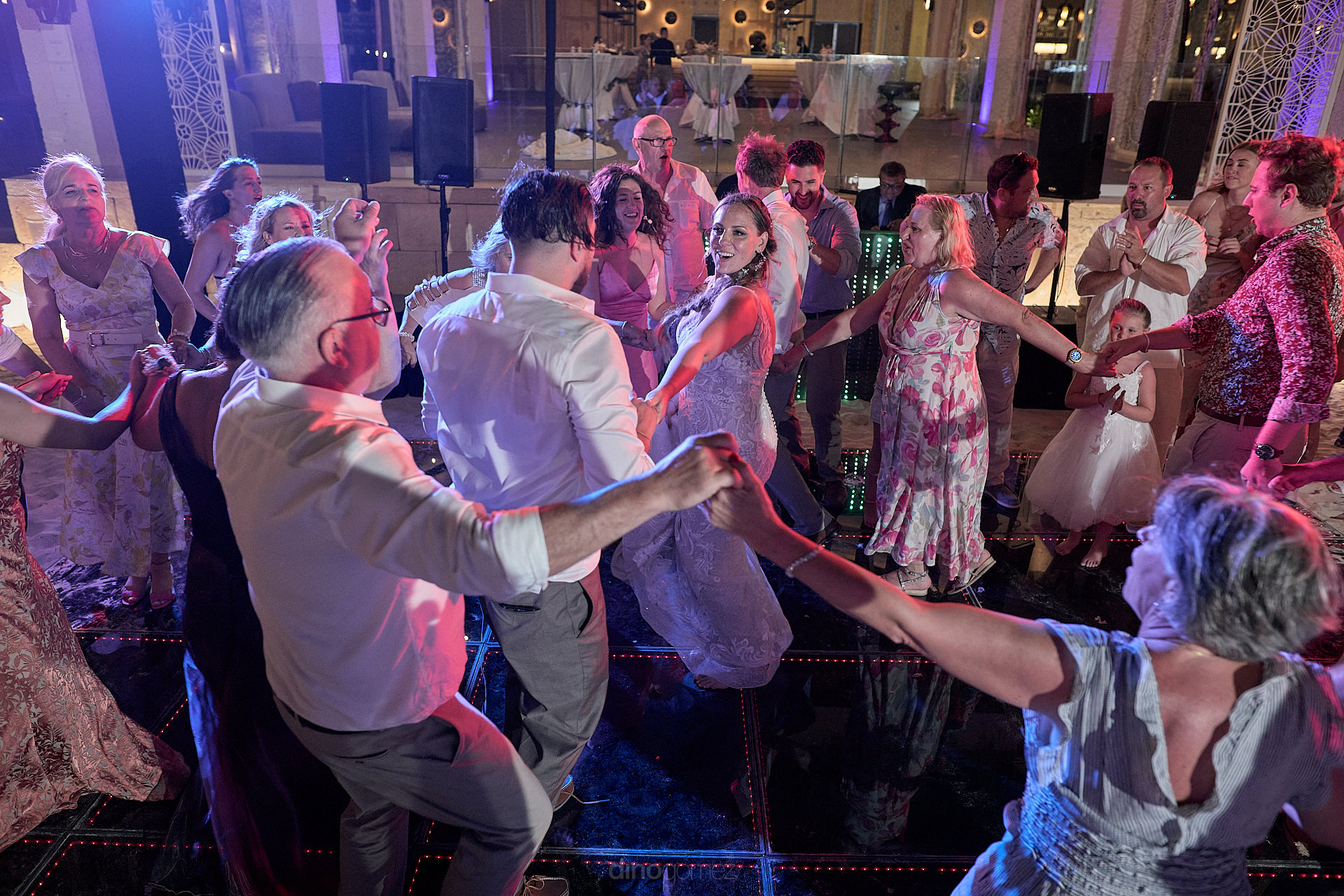 a group of people dancing on a dance floor.