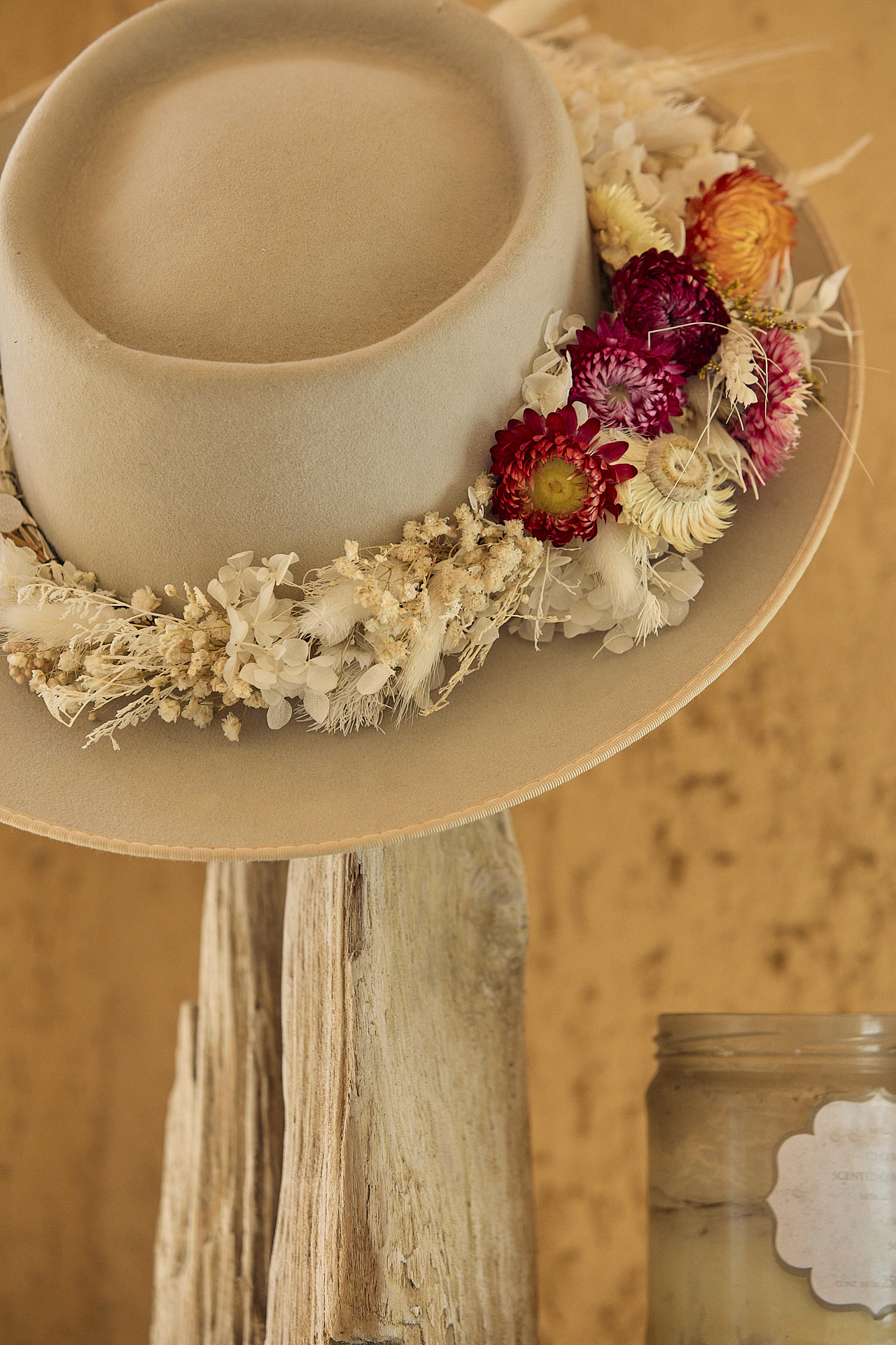 a white hat with flowers on top of it.