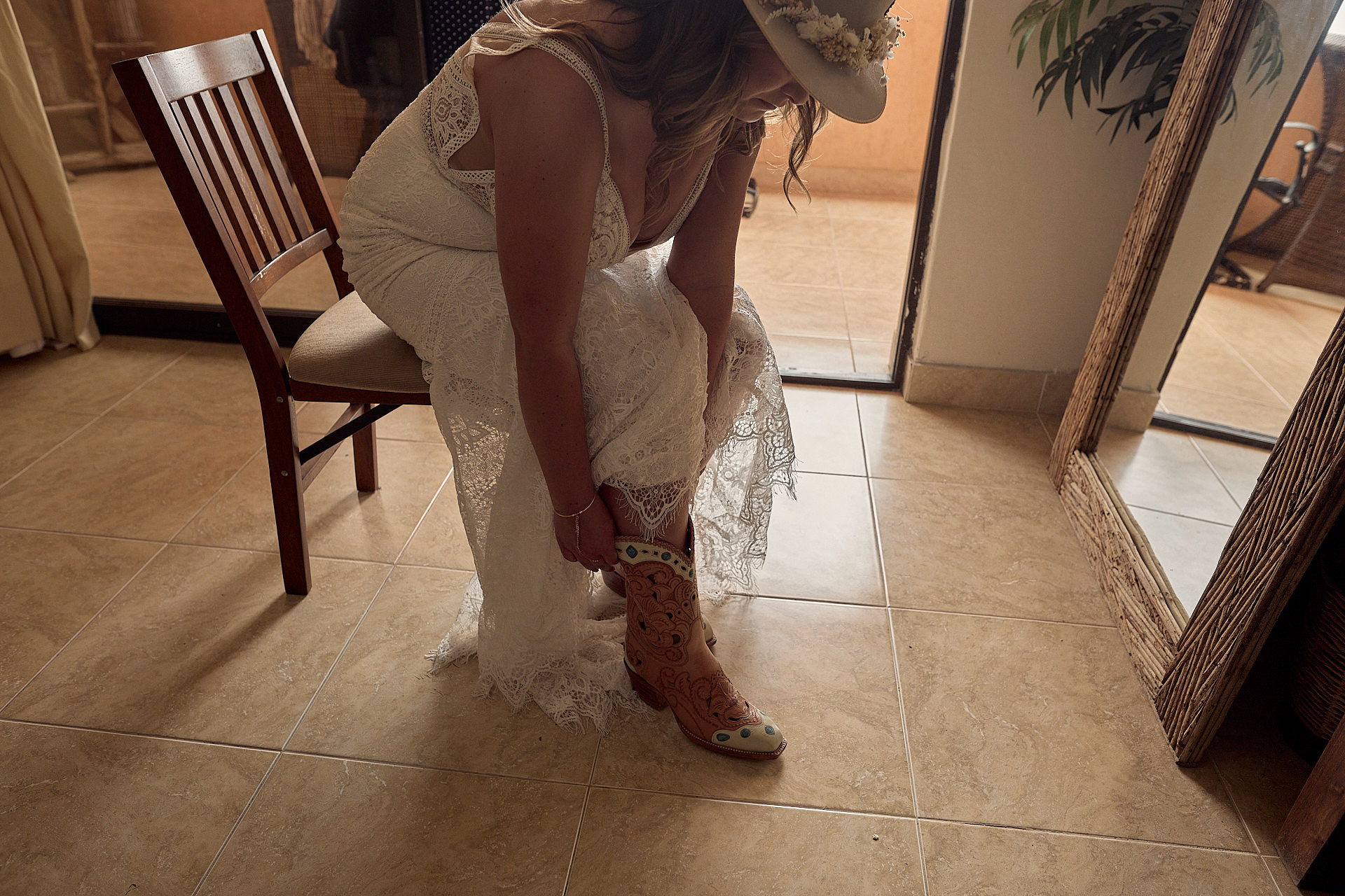 a woman in a white dress kneeling down on a tile floor.