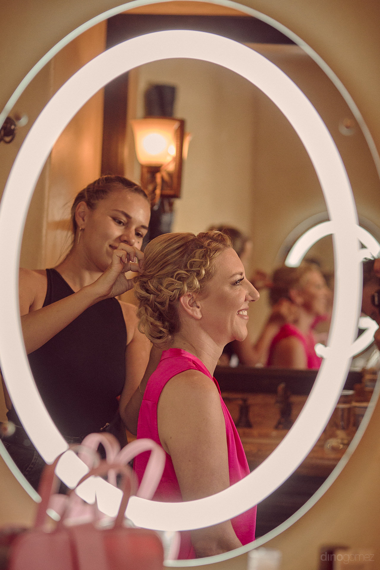 A Woman Is Getting Her Hair Done In A Mirror.
