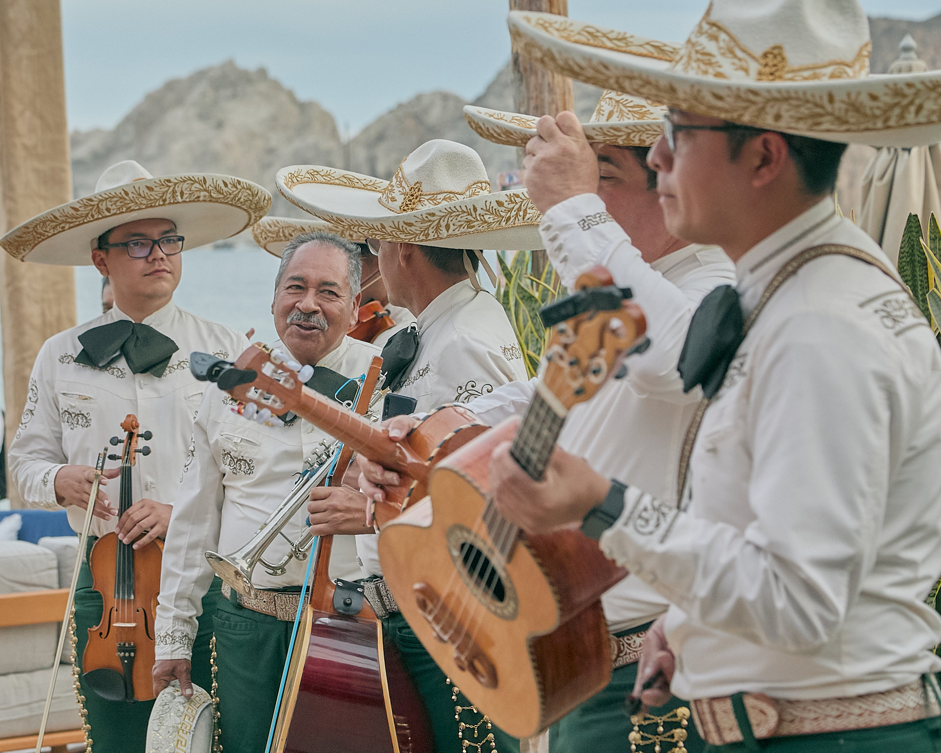 a group of men wearing sombreros and playing instruments.