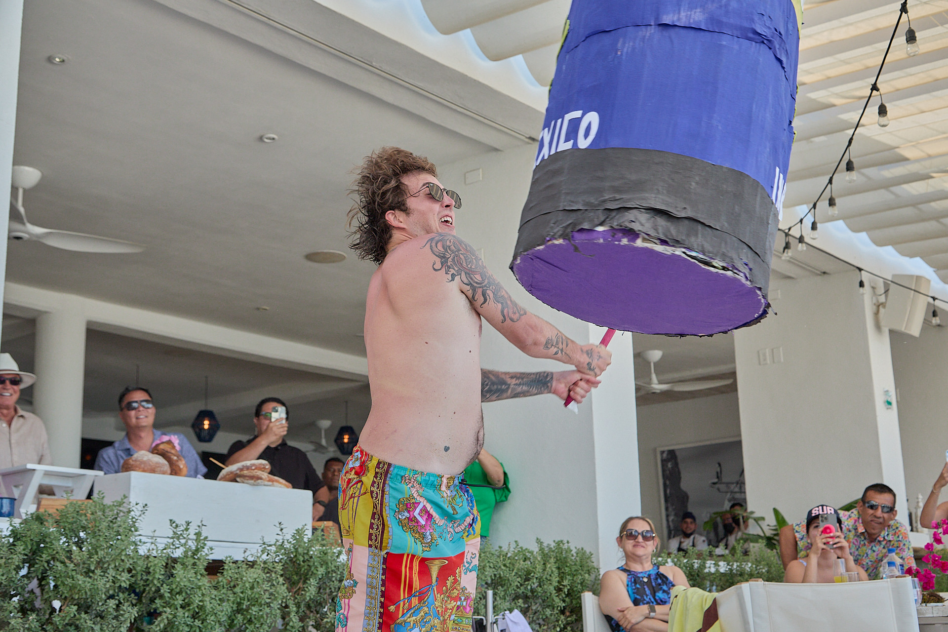 a man holding a giant purple object in his hand.