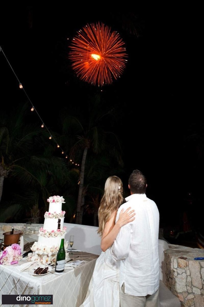 Happy Couple Watching Fireworks At Their Wedding In Cabo